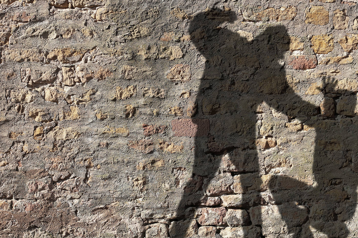 Silhouette of a man assaulting another man