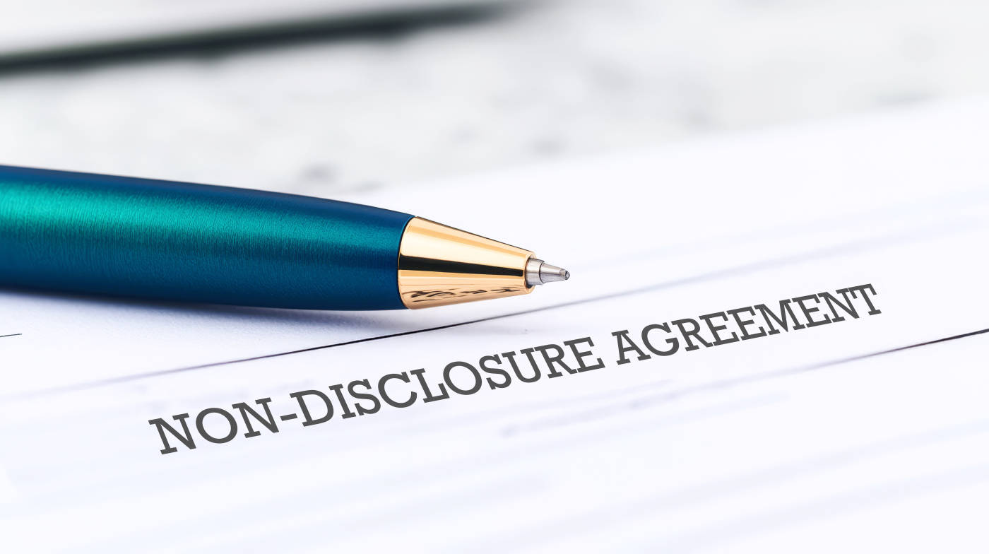 Non-disclosure agreement paper with pen