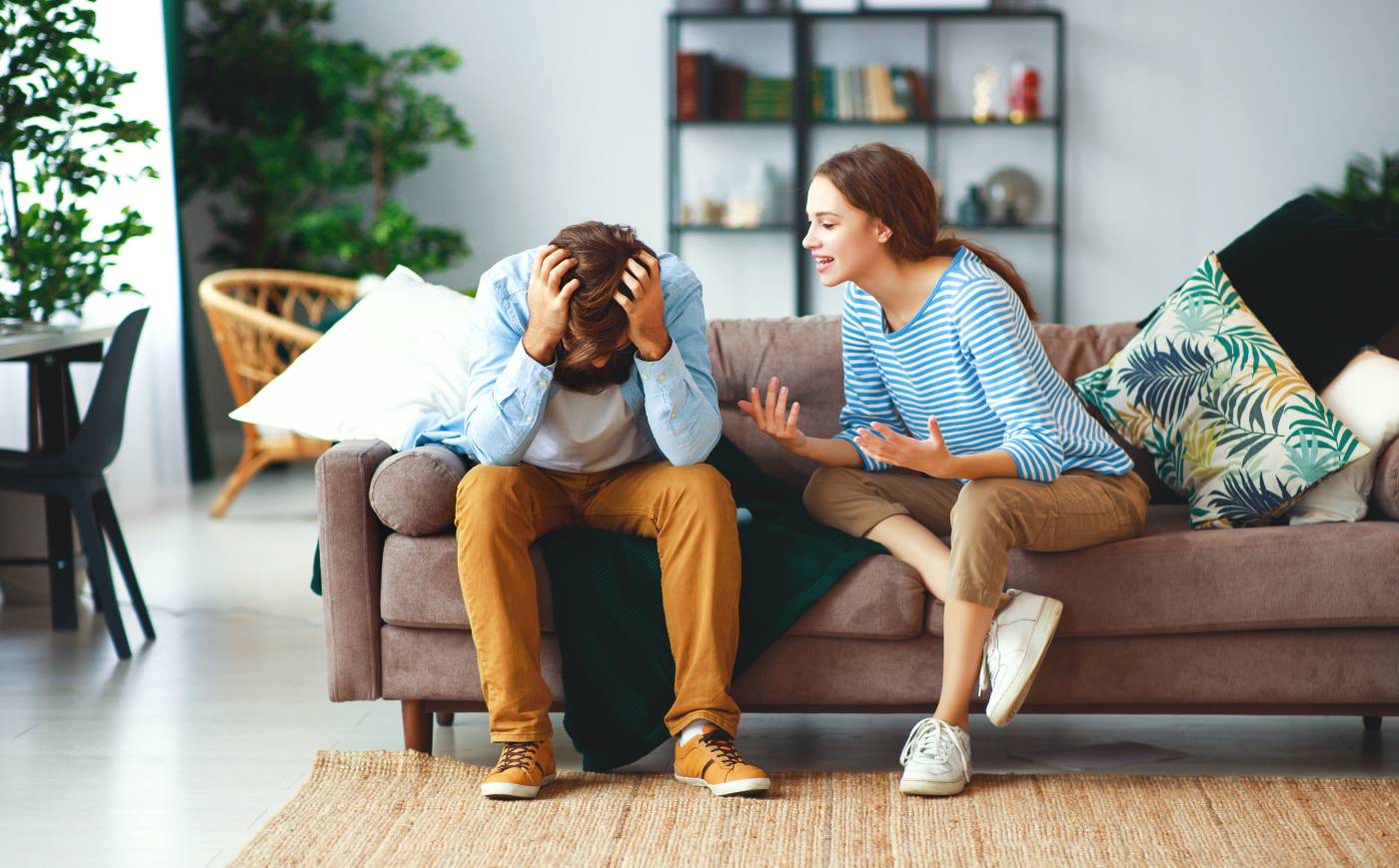 frustrated couple argues on couch