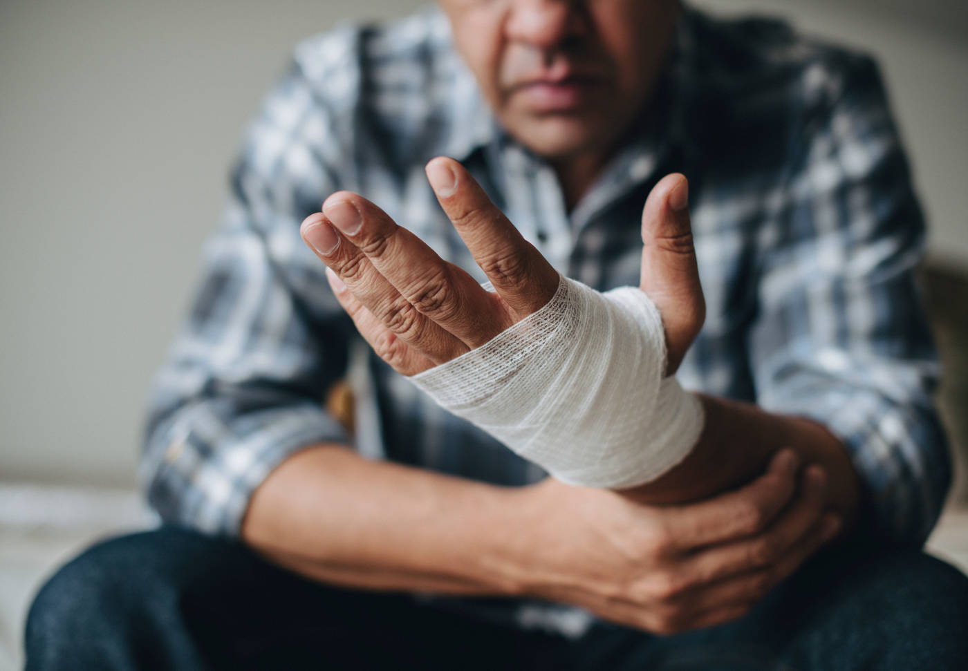 Man with a gauze bandage wrapped around his hand