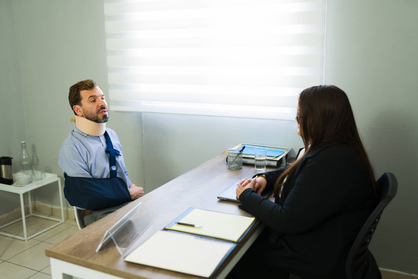 Injured man consulting with lawyer