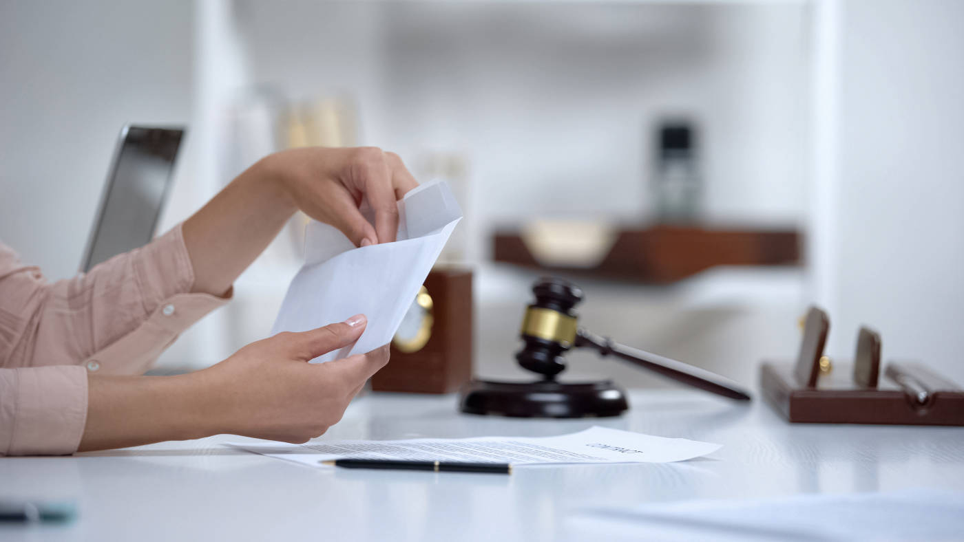 Divorced woman holding envelope with spousal support money