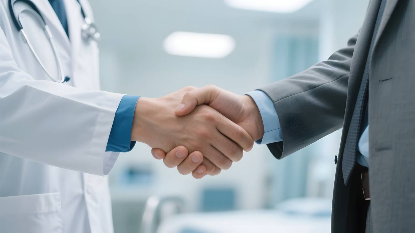 Doctor and businessman shaking hand