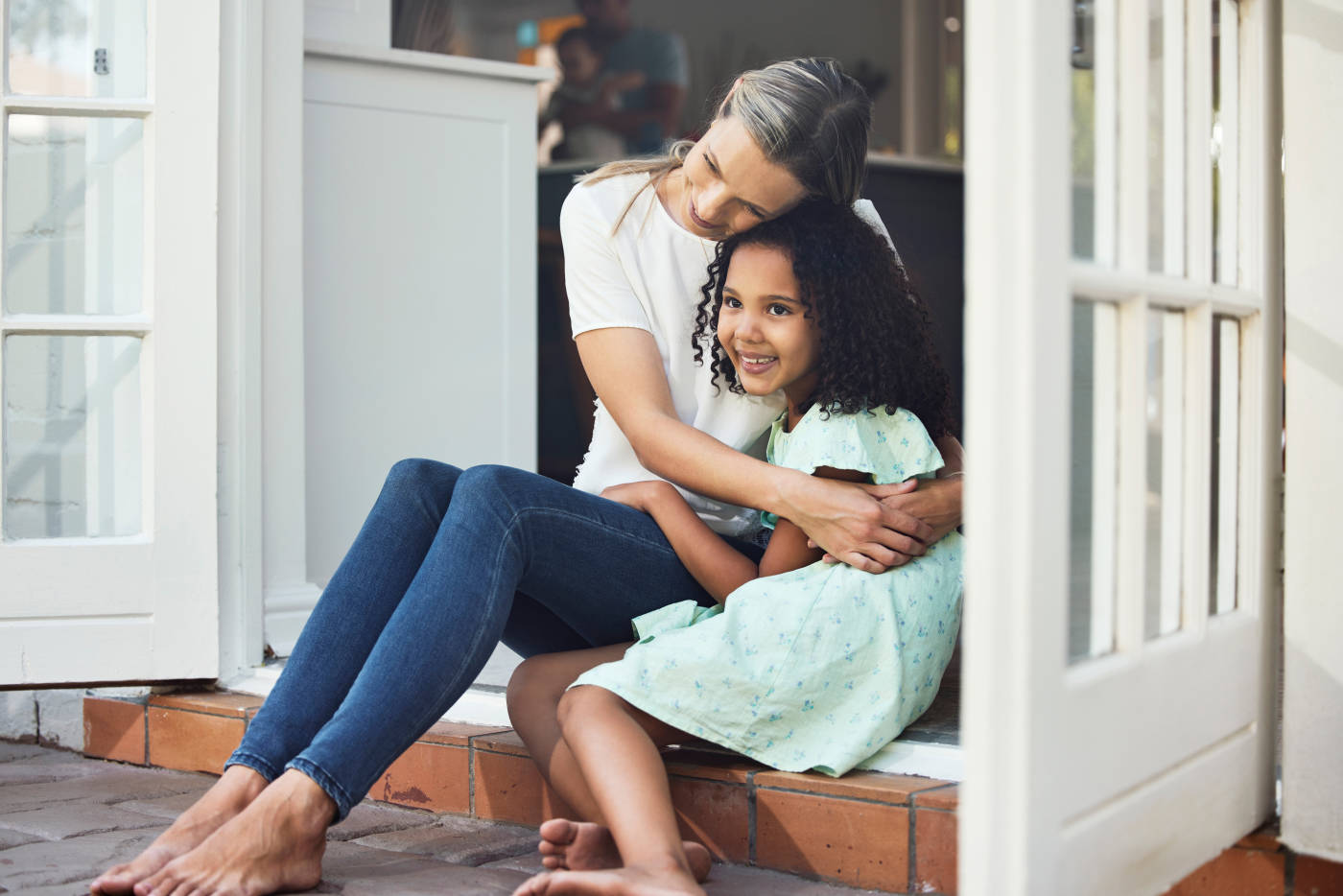 Women embracing a foster kid