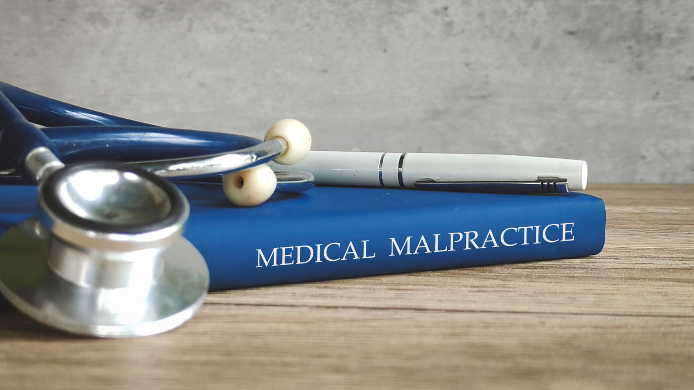 Stethoscope and Medical Malpractice Law Book