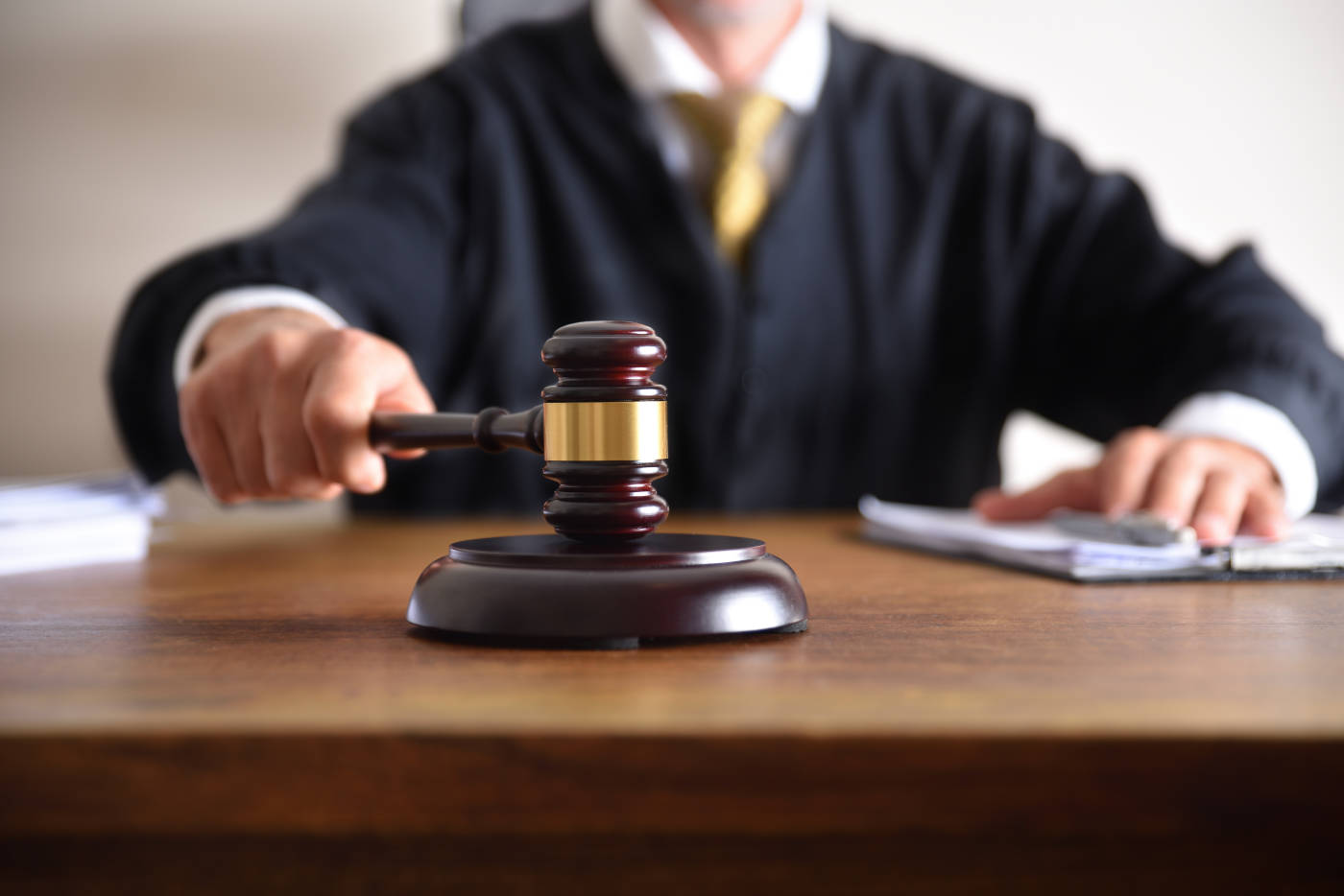 Judge passing sentence by hitting with gavel closeup
