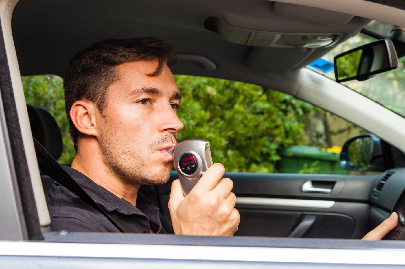Man blowing into breathalyzer