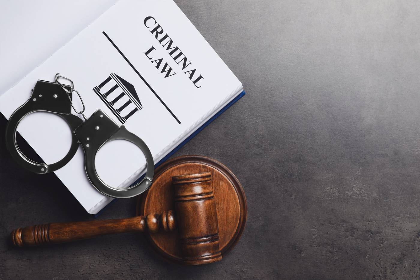 handcuffs and gavel on a desk