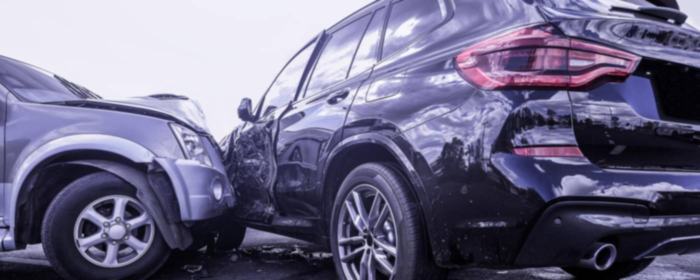 a silver car hitting a black suv