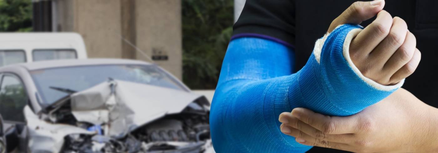 Person with cast on arm walking away from car accident