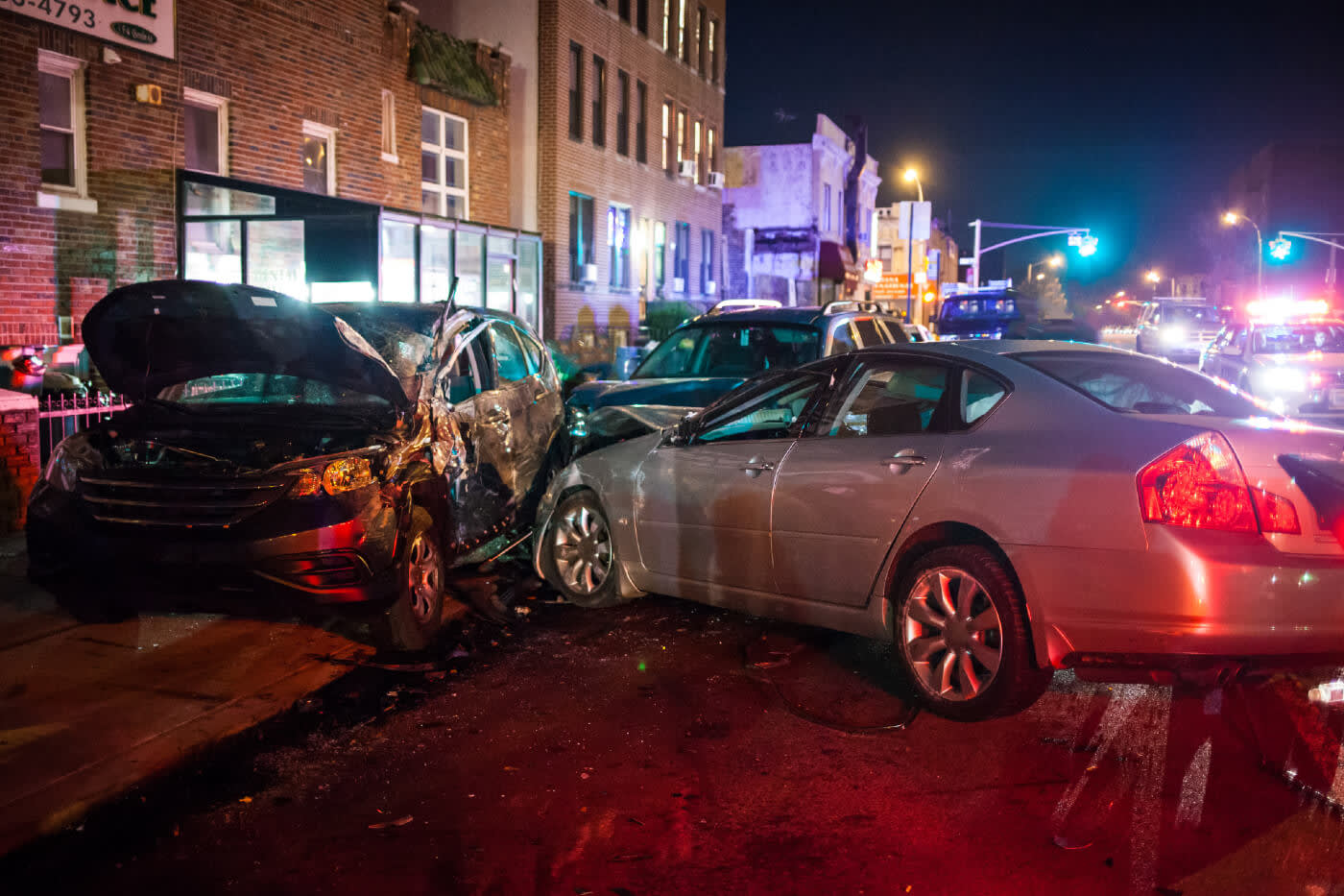 Damaged cars after accident in the street at night