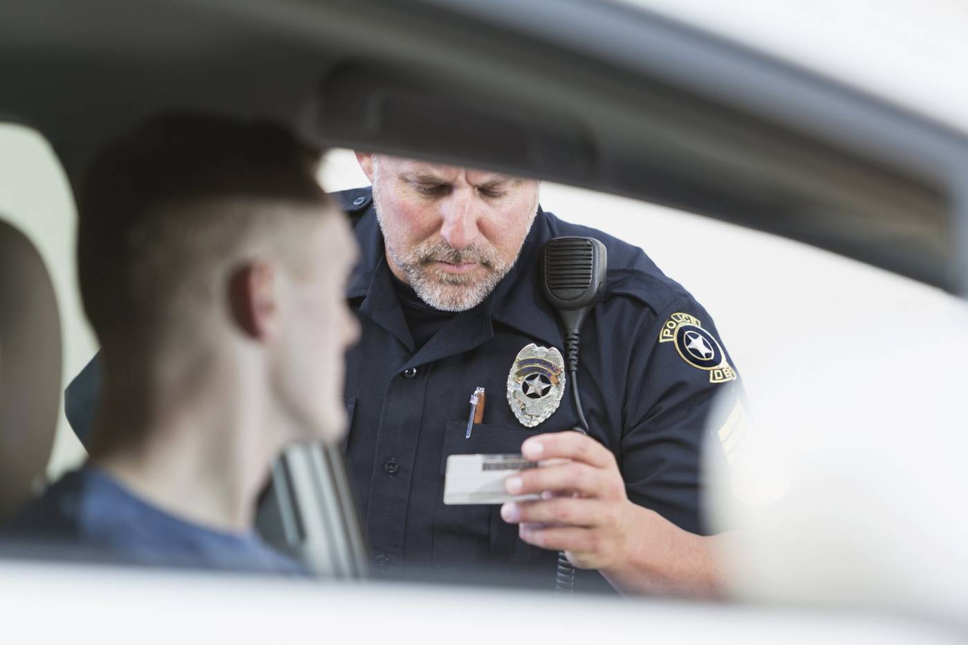 Police Officer Looking at Driver License
