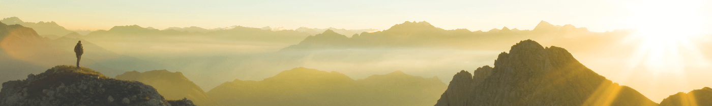 Person on top of the Mountain and the Sun