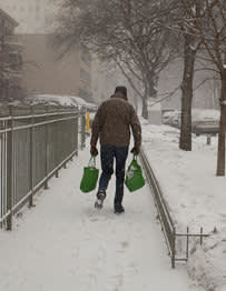 Man carrying groceries in the snow