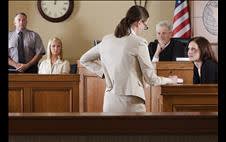 Lawyer asking questions of a witness in a courtooom 