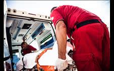 Patient being carried into an ambulance 