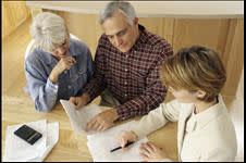 Older couple looking at estate planning documents with an attorney 