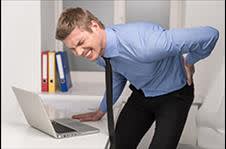 Businessman hunched over holding his back in pain