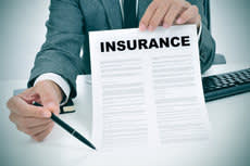 Businessman holding up an insurance document