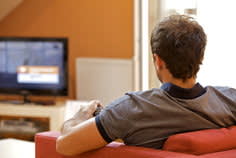 Man sitting on couch walking TV