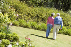 Senior couple walking in a field 