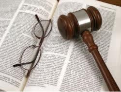 Law book with gavel and glasses