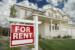 For Rent sign in front of a white house