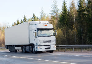 Semi-truck driving down the road