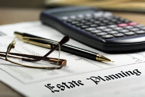 Estate planning document with a calculator, pen, and pair of glasses