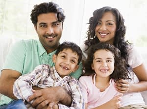 Couple with their kids smiling for a photo