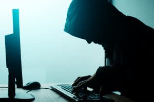 man wearing black hoodie on computer