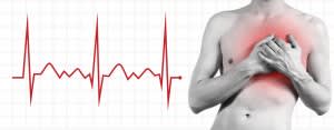 Shirtless man holding chest while a graph tracks his heartbeat