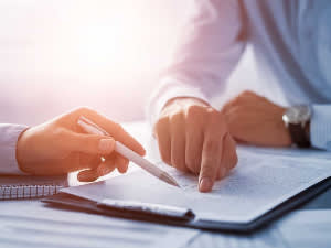 Attorney reviewing documents and pointing out something to client