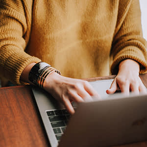 Woman typing at computer