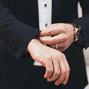 Businessman in suit adjusting his cuffs