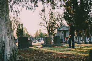 Man visiting a gravesite