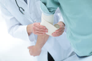 Doctor tending to a patient's arm