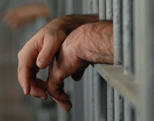hands through jail bars
