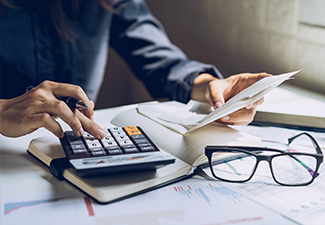 woman checking account balance and calculating expenses at home.