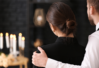 Couple pining after their relative at funeral