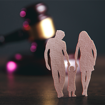 Family figure and gavel on table