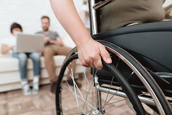 Woman in wheelchair, family behind her looking at options