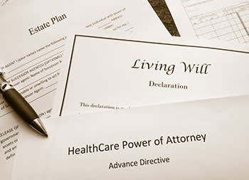 Estate plan, living will, and healthcare power of attorney documents on a desk