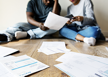 A man and woman go through bank documents