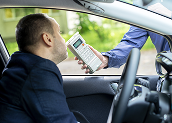 A man receives a sobriety test in his car