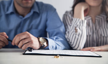 A man and woman look over documents 