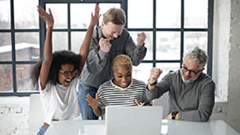 People celebrating around a computer