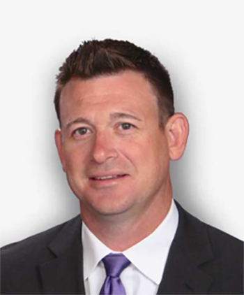 Coyne in a suit and tie