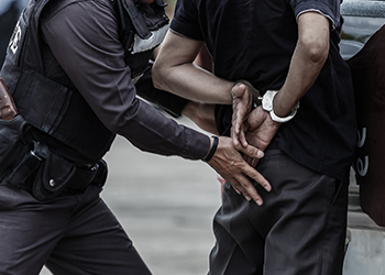 Man being arrested by a police office