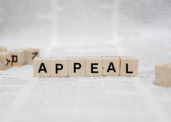 Appeal spelled out in letter tiles on a book page background